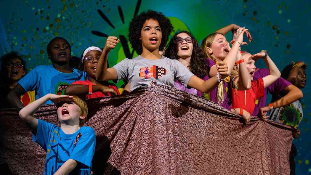 Coram Shakespeare Schools Festival Performance Featuring a group of young performers raising there fists in defiance